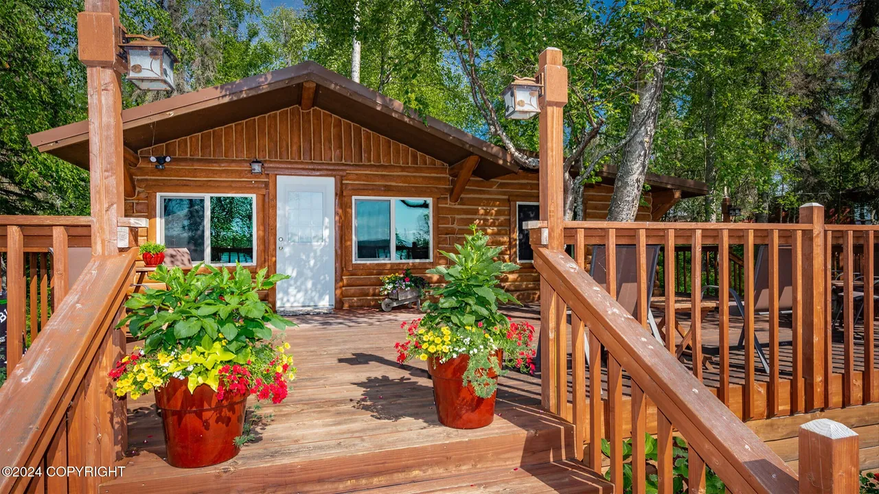 Standalone guest cabin with fire pit and lounge chairs